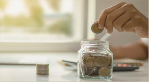 Hand putting change in a jar