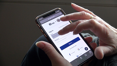 Image of person accessing policy online on a smartphone